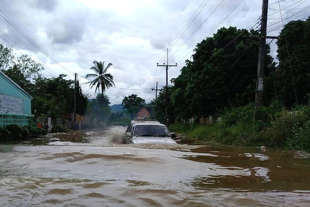 This handout photo taken and released by the Hill Area and Community Development Foundation on September 11, 2024 shows a car driving through flood waters in Chiang Rai, following heavy rains in the aftermath of Typhoon Yagi. Thai authorities said four people were killed in the kingdom's northern provinces of Chiang Mai and Chiang Rai and the army has been deployed to help around 9,000 flood-hit families. (Photo by Handout/Hill Area and Community Development Foundation/AFP Photo)