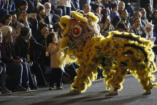 A spectator reacts to dancers dressed in a lion costume during the Chinese New Year Parade in San Francisco on Saturday, February 8, 2020. (Photo by Josie Lepe/AP Photo)