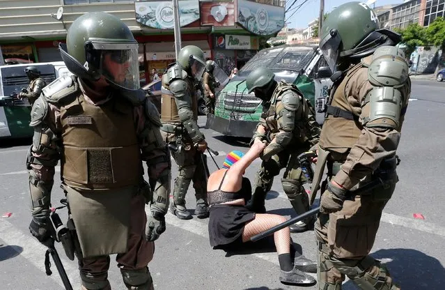 A woman is detained by security forces during a rally and strike as part of International Women's Day activities in Valparaiso, Chile on March 9, 2020. (Photo by Rodrigo Garrido/Reuters)