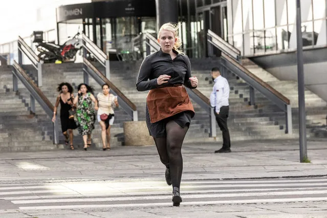 People run during the evacuation of the Fields shopping mall, where a gunman killed three people and wounded several others in Copenhagen, Denmark, on July 3, 2022. A 22-year-old Danish man was arrested after the shooting but his motives were unclear, police said. (Photo by Olafur Steinar/Ritzau Scanpix via AFP Photo)