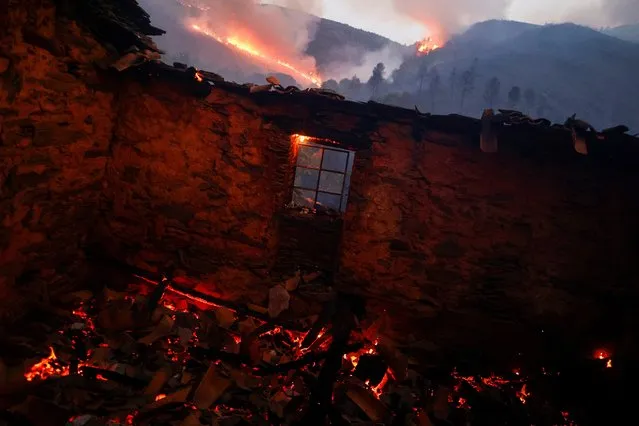 View inside a burned house during a wildfire in Videmonte, Celorico da Beira, Portugal on August 11, 2022. (Photo by Pedro Nunes/Reuters)