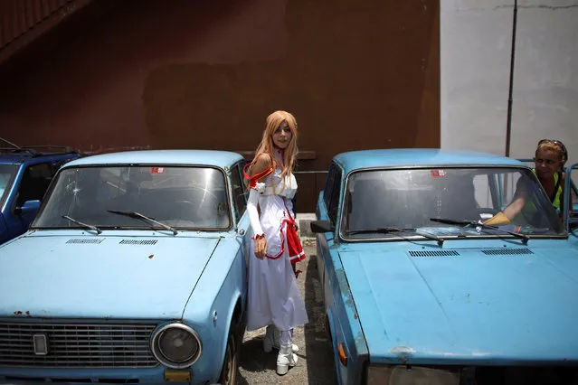 Massiel Alvarez, 18, enters a car at the end  of the Cuban Otaku festival in Havana, Cuba, July 24, 2016. (Photo by Alexandre Meneghini/Reuters)