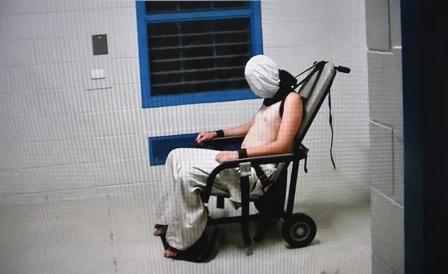 This frame grab from Australian Broadcasting Corporation's (ABC) Four Corners program broadcast in Australia on July 25, 2016 and released on July 26, 2016 allegedly shows a teenage boy hooded and strapped into a chair at a youth detention centre in the Northern Territory city of Darwin. The Australian government ordered an inquiry on July 26 after graphic evidence emerged of prison guards assaulting teenage boys, with one shown hooded and shackled in scenes likened to Guantanamo Bay. (Photo by AFP Photo/Australian Broadcasting Corp)