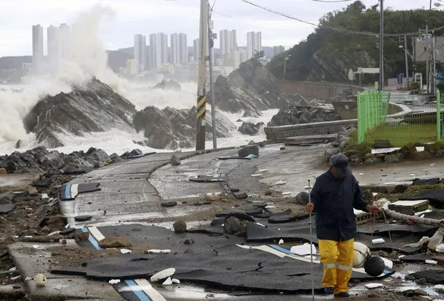 A road is damaged as waves hit a shore in Ulsan, South Korea, Tuesday, September 6, 2022. The most powerful typhoon to hit South Korea in years battered its southern region Tuesday, dumping almost a meter (3 feet) of rain, destroying roads and felling power lines, leaving 20,000 homes without electricity as thousands of people fled to safer ground. (Photo by Kim Yong-tai/Yonhap via AP Photo)