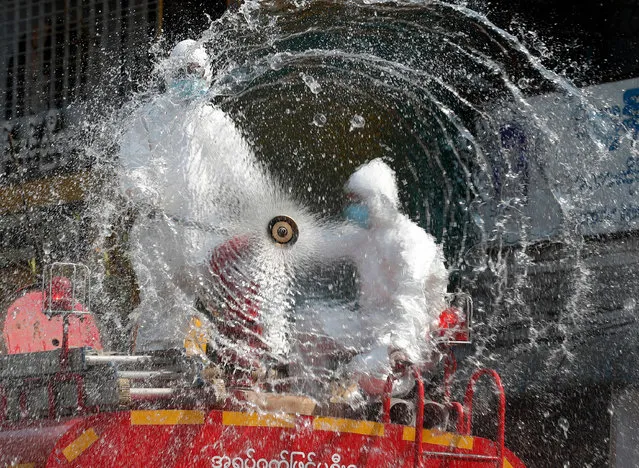 Firefighters spray disinfectant at a market to curb the spread of coronavirus in Yangon, Myanmar, 20 April 2020. Countries around the world are taking increased measures to stem the widespread of the SARS-CoV-2 coronavirus which causes the Covid-19 disease. (Photo by Nyein Chan Naing/EPA/EFE/Rex Features/Shutterstock)