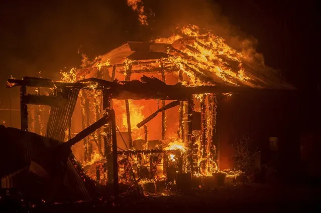 A residence on Siegler Canyon Road burns as the Valley Fire rages through Middletown, California September 13, 2015. (Photo by Noah Berger/Reuters)
