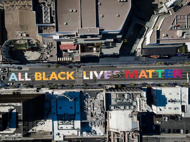 A photo taken with a drone shows people painting an “All Black Lives Matter” mural on Hollywood Boulevard in Hollywood, California, USA, 13 June 2020. An eyewitness video showing the deadly arrest of 46-year-old African-American George Floyd in Minneapolis on 25 May sparked worldwide protests against police brutality. (Photo by Christian Monterrosa/EPA/EFE)