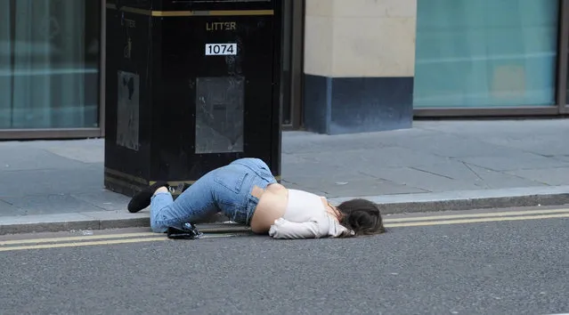 A reveller falls over into the road in Newcastle, Britain, July 4, 2020 on the day pubs and restaurants were finally allowed to reopen. (Photo by North News and Pictures)