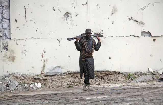 A Somali soldier stands at the scene of a suicide car bomb near the port in Mogadishu, Somalia Saturday, July 4, 2020. Explosions rocked two of Somalia's largest cities on Saturday as officials said a suicide car bomber detonated near the port in Mogadishu and a land mine was detonated by remote control as people were dining in a restaurant on the outskirts of Baidoa. (Photo by Farah Abdi Warsameh/AP Photo)