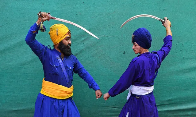 Nihangs or Sikh warriors pose for a photo while holding swords ahead of the birthday celebration of Guru Nanak Dev Ji in Mumbai on November 7, 2022. Gatka is a Punjabi word that translates to wooden sticks, which are used instead of swords. it uses a sword as the main weapon, amongst others. person's spiritual and physical aspect is developed during the learning phase of this ancient art. Gatka was extensively used by Sikh warriors to defend themselves from the atrocities of the Mughals and the British rulers. (Photo by Ashish Vaishnav/SOPA Images/Rex Features/Shutterstock)