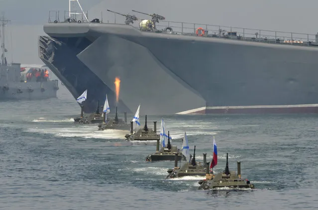 Russian amphibious vehicles drive in formation during celebrations to mark Navy Day in the far eastern Russian port of Vladivostok, July 27, 2014. (Photo by Yuri Maltsev/Reuters)
