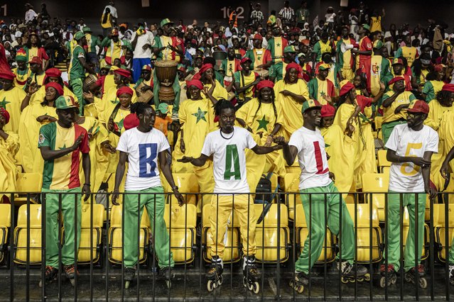ASC Ville de Dakar supporters dance during the final game of the Basketball Africa League (BAL) Sahara Conference against Union Sportive Monastirienne at the Dakar Arena in Diamniadio, on May 4, 2025. ASC Ville de Dakar participated for the first time in the Africa Basketball League (BAL) after winning the Senegal championship in 2024, during the Sahara Conference against teams from Tunisia, Angola and Cape Verde. The Basketball Africa League (BAL) is a partnership between the International Basketball Federation (FIBA) and the National Basketball Association (NBA) that brings together 12 teams showcasing some of the best players from across the continent. Rabat and Dakar have already hosted their respective conferences with Kigali hosting the Nile Conference on May 2025. The finals will take place in Pretoria on June 2025. (Photo by Patrick Meinhardt/AFP Photo)