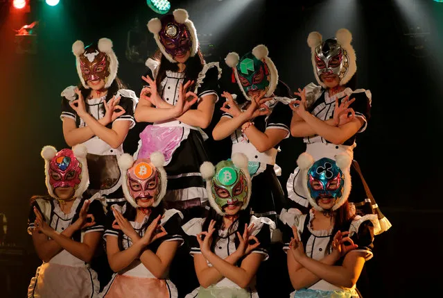 Members of Japan's idol group “Virtual Currency Girls” wearing cryptocurrency-themed masks perform in their debut stage event in Tokyo, Japan, January 12, 2018. In their debut, the eight “Virtual Currency Girls”, or Kasotsuka Shojo in Japanese, cavorted in maid costumes with frilly skirts and full-face professional wrestling-style masks with fuzzy pom-pom ears, extolling the virtues of decentralized digital currencies such as bitcoin. (Photo by Kim Kyung-Hoon/Reuters)