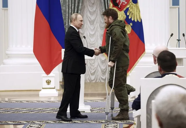 Russian President Vladimir Putin, left, awards founder of the WarGonzo media project Semyon Pegov with the Order of Courage during an awarding ceremony at the Kremlin's St. Catherine Hall in Moscow, Russia, Tuesday, December 20, 2022. (Photo by Valeriy Sharifulin, Sputnik, Kremlin Pool Photo via AP Photo)