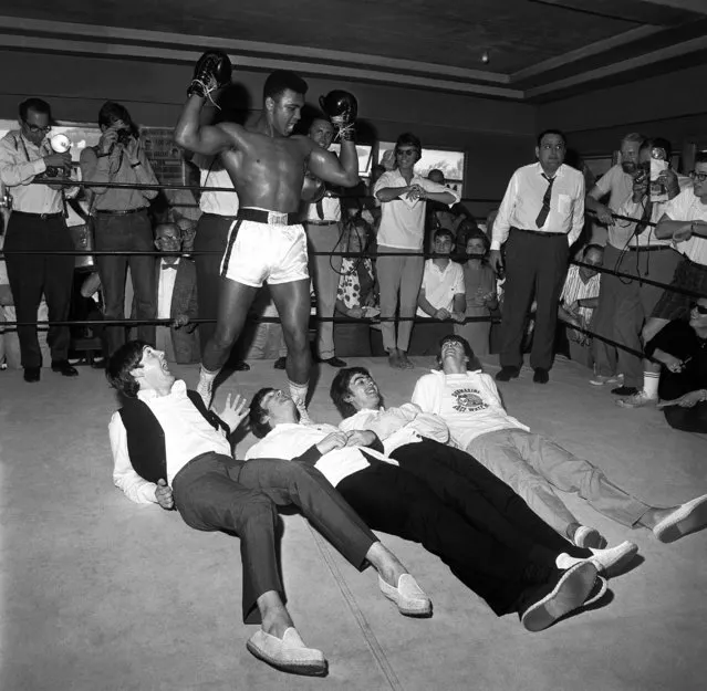 Cassius Clay poses in a mock victory over the Beatles, at his training camp in Miami, Fla., 1964. (Clay changed his name to Muhammad Ali after his win against Sonny Liston). (Photograph from “Harry Benson: Persons of Interest” by Harry Benson, published by powerHouse Books)