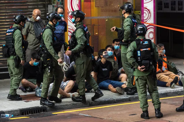 Police detain people as they patrol the area after protesters called for a rally in Hong Kong on September 6, 2020 to protest against the government's decision to postpone the legislative council election due to the COVID-19 coronavirus, and the national security law. Nearly 100 people were arrested by Hong Kong police on September 6 as riot officers swooped on democracy protesters opposed to the postponement of local elections. (Photo by Dale De La Rey/AFP Photo)