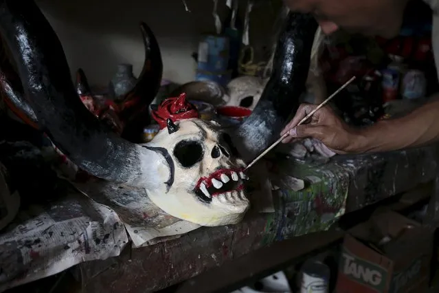A man paints a devil mask in preparation for the Los Aguizotes festival in the indigenous community of Monimbo in Masaya, Nicaragua, October 16, 2015. (Photo by Oswaldo Rivas/Reuters)