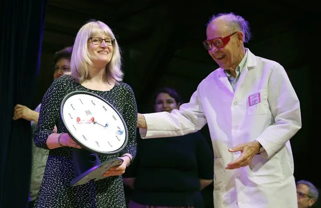 Susanne Akesson, left, accepts the Ig Nobel prize in physics from Nobel laureate Dudley Herschbach (chemistry, 1986) during ceremonies at Harvard University in Cambridge, Mass., Thursday, September 22, 2016. Akesson, from Lund University in Sweden, was part of a team that discovered why white-haired horses are the most horsefly-proof horses and for discovering why dragon flies are fatally attracted to black tombstones. (Photo by Michael Dwyer/AP Photo)