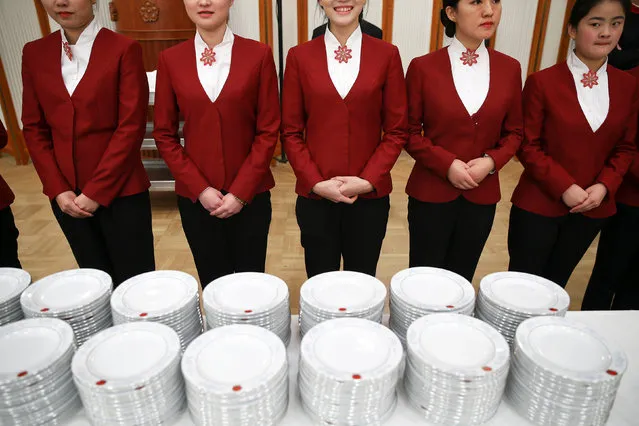 Attendants wait to serve food before the start of a reception to celebrate National Day at the Great Hall of the People in Beijing, China September 30, 2016. (Photo by Damir Sagolj/Reuters)