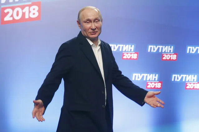 Russian President Vladimir Putin gestures during a news conference after meeting with his staff at the campaign headquarters in Moscow, Russia, Sunday, March 18, 2018. Russian President Vladimir Putin has dodged a question about his plans after serving another six-year term he has won. Putin wouldn't be eligible under the constitution to compete in the 2024 election since there is a limit of two consecutive terms. (Photo by Sergei Chirikov/Pool photo via AP Photo)