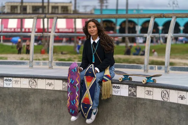 Di'Orr Greenwood, an artist born and raised in the Navajo Nation in Arizona and whose work is featured on the new U.S. stamps, poses for a picture with her skateboards in the Venice Beach neighborhood in Los Angeles Monday, March 20, 2023. On Friday, March 24, the U.S. Postal Service is debuting the “Art of the Skateboard”, four stamps that will be the first to pay tribute to skateboarding. The stamps underscore how prevalent skateboarding has become, especially in Indian Country, where the demand for designated skate spots has only grown in recent years. (Photo by Damian Dovarganes/AP Photo)