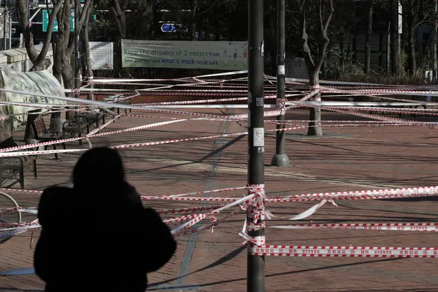 A park is taped off for the social distancing measures and a precaution against the coronavirus in Seoul, South Korea, Wednesday, December 16, 2020. (Photo by Lee Jin-man/AP Photo)