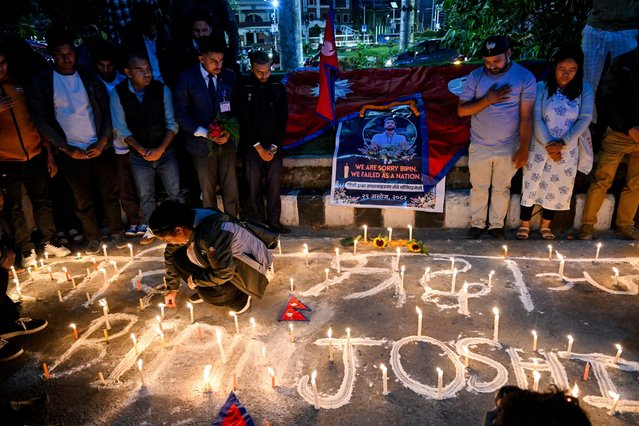 Mourners light candles and offer condolences in Kathmandu on October 15, 2025, during a candlelight vigil held for Bipin Joshi, a deceased Nepali agricultural student who died while being held hostage in Gaza by the Palestinian militant group Hamas. The Israeli military said on October 14, that the bodies of four hostages returned by Hamas following a US-brokered truce have been identified, including that of a Nepalese student. (Photo by Prakash Mathema/AFP Photo)