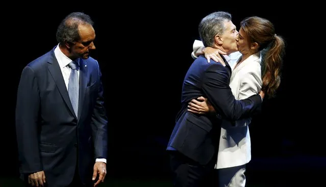 Mauricio Macri, presidential candidate for the Cambiemos (Let's Change) alliance, kisses his wife Juliana Awada as Argentina's ruling party candidate Daniel Scioli watches at the end of the presidential debate ahead of November 22 run-off election in Buenos Aires, November 15, 2015. (Photo by Marcos Brindicci/Reuters)