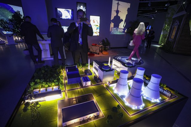 Visitors look at displays at the World Atomic Week International Forum at the VDNKh Exhibition Centre in Moscow, Russia, 25 September 2025. The World Atomic Week international forum, the largest event dedicated to the nuclear and related industries, is being held at the VDNKh Exhibition Centre in Moscow from 25 to 28 September. (Photo by Maxim Shipenkov/EPA)