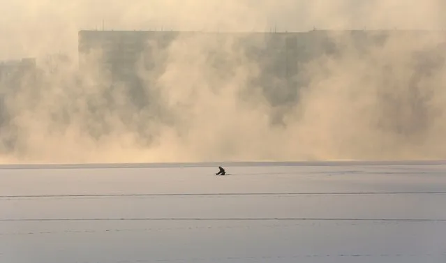A man fishes on an ice-covered part of the Yenisei River, with the air temperature at about minus 20 Celsius (minus 4 degrees Fahrenheit), in the Siberian city of Krasnoyarsk, Russia November 21, 2015. (Photo by Ilya Naymushin/Reuters)