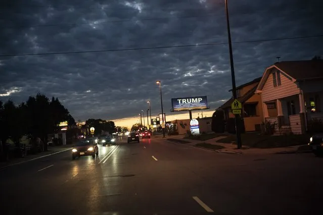 In this October 31, 2020, file photo, a billboard for President Donald Trump is illuminated along a street in Kenosha, Wis. (Photo by Wong Maye-E/AP Photo/File)