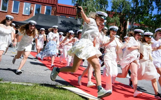 Students run out of their school celebrating their high school graduation at Nacka Gymnasium following the spread of the corona virus disease (COVID-19) in Stockholm, Sweden, June 3, 2020. (Photo by Jessica Gow/TT News Agency via Reuters)