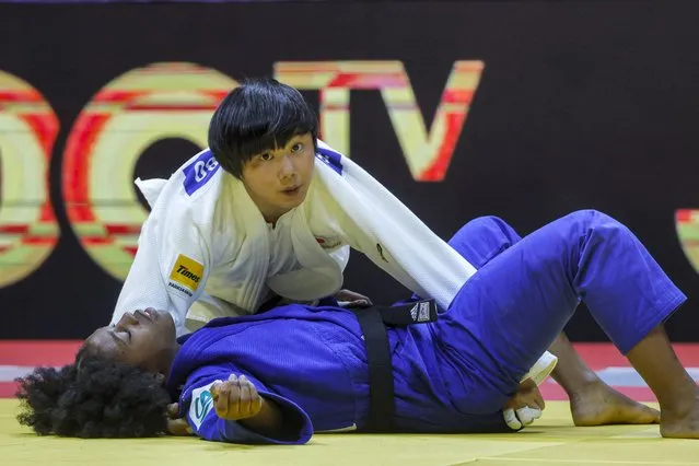 Japan's Haruka Funakubu (white) competes against France's Sarah-Leonie Cysique during the teams mixed final bout at the World Judo Championship in Doha on May 14, 2023. (Photo by Karim Jaafar/AFP Photo)