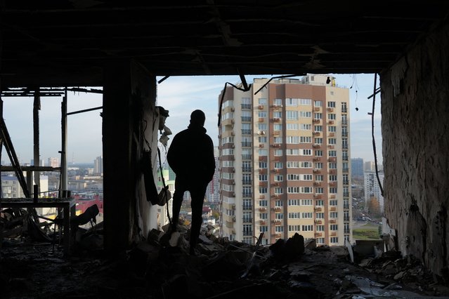 A person stands in a destroyed apartment in a damaged residential building following an air strike in Kyiv, on November 14, 2025, amid the Russian invasion of Ukraine. A Russian attack overnight, mostly targeting the capital Kyiv, killed four people and damaged buildings across the city, Ukrainian authorities said on November 14, 2025. (Photo by Oleksii Filippov/AFP Photo)