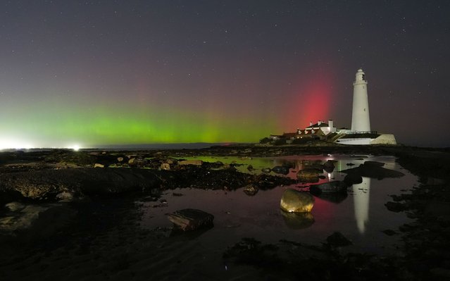 The aurora borealis, also known as the northern lights
, glow in the sky over St Mary's Lighthouse in Whitley Bay on the North East coast, UK on Thursday, October 30, 2025. (Photo by Owen Humphreys/PA Images via Getty Images)