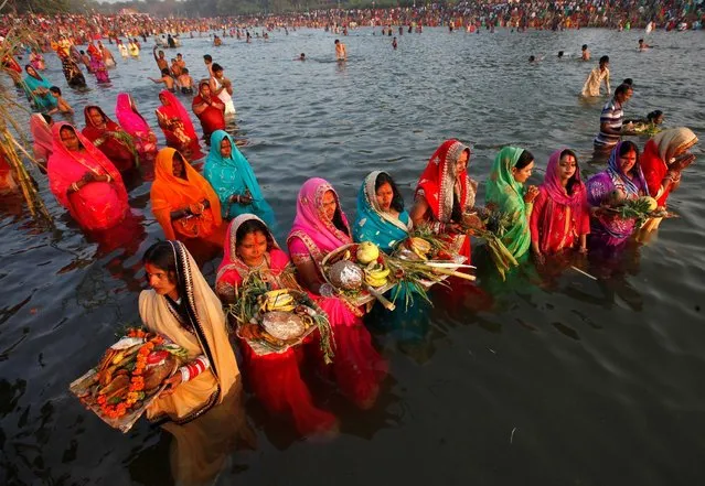Hindu devotees worship the Sun god in the waters of the Sun Lake during the religious festival of Chhat Puja in Chandigarh, India, November 6, 2016. (Photo by Ajay Verma/Reuters)