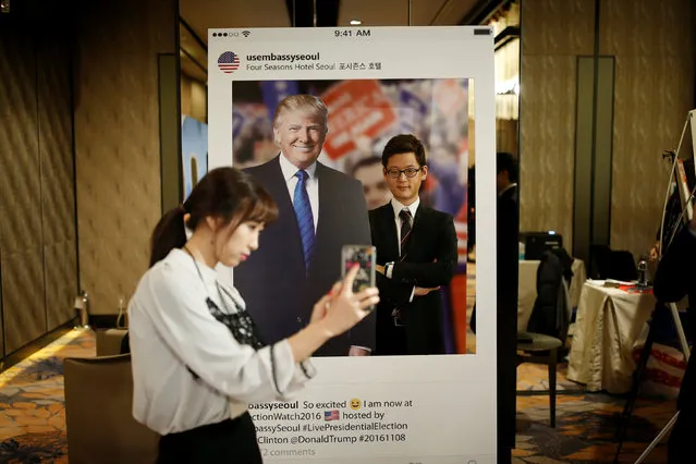 A woman takes a photograph of her friend with a cut-out of Republican U.S. presidential nominee Donald Trump during a U.S. Election Watch event hosted by the U.S. Embassy at a hotel in Seoul, South Korea, November 9, 2016. (Photo by Kim Hong-Ji/Reuters)