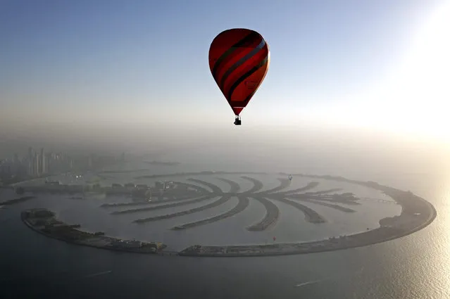 Hot Air Aerostat flies over The man-made Palm island during Dubai International Balloon Fiesta as part of the last day of Dubai Air Games 2015 in Gulf emirate of Dubai, United arab Emirates on 12 December 2015. (Photo by Ali Haider/EPA)