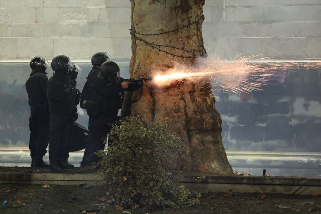 Police fire tear gas toward protesters during the fifth straight night of demonstrations against the government's postponement of EU accession talks until 2028, in central Tbilisi early on December 3, 2024. (Photo by Giorgi Arjevanidze/AFP Photo)