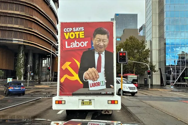 A truck sponsored by conservative lobby group Advance Australia displaying an image of Chinese President Xi Jinping casting a vote for the Australian opposition Labor Party drives down a local street, Saturday, April 9, 2022, in the Parramatta area of Sydney. Australia's Defense Minister Peter Dutton says there is evidence that the Chinese Communist Party wants Australia's government to change at the May 21 election because a center-left Labor Party administration would attempt to appease Beijing. (Photo by AP Photo/Stringer)