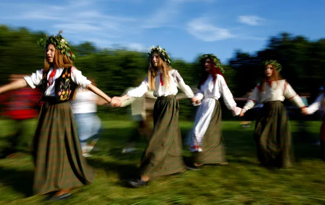 Belarusian women take part in the Ivan Kupala festival in Belarusian state museum of folk architecture and rural lifestyle near the village Aziarco, Belarus, July 7, 2018. (Photo by Vasily Fedosenko/Reuters)