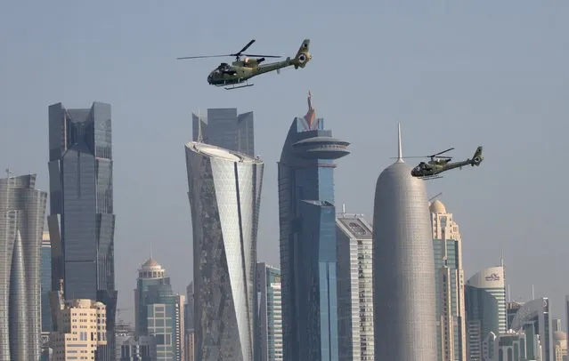 Military helicopters fly over Doha during Qatar's National Day celebrations December 18, 2015. (Photo by Naseem Zeitoon/Reuters)