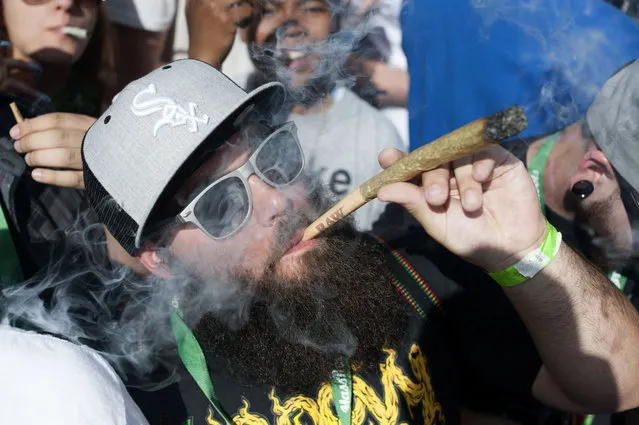 This file photo taken on May 22, 2016 shows people attending the Denver 420 Rally, the world's largest celebration of both the legalization of cannabis and cannabis culture in Denver, Coloroado, which on November 15, 2016 became the first city in the United States to legalize the social use of cannabis in businesses, including bars, yoga studios and art galleries. The new ordinance was part of several marijuana measures put to voters in nine US states during the November 8, 2016 general election. (Photo by Jason Connolly/AFP Photo)