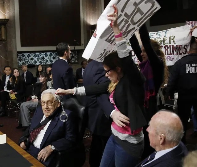 Code Pink demonstrators surround former United States Secretaries of State Henry Kissinger (L) and George Shultz (R) before the beginning of the Senate Armed Services Committee on global challenges and U.S. national security strategy on Capitol Hill in Washington January 29, 2015. (Photo by Gary Cameron/Reuters)