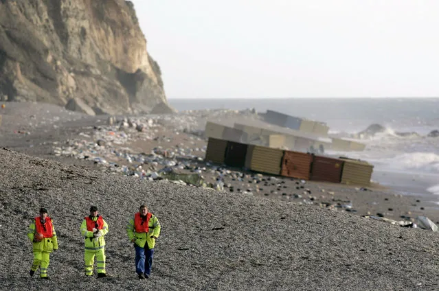 Coastguards walk pass cargo spilled from the ship MSC Napoli at Branscombe, southern England, January 21, 2007. (Photo by Luke MacGregor/Reuters)