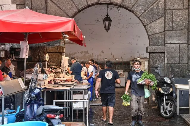 “A piscaria” the traditional and historical fish market of Catania always crowded with tourists and people who buy fresh fish on September 22, 2020 in Catania, Italy. Visitors and Fish sellers at the historic fish market are failing to wear face coverings despite Italy's rising cases in Covid-19 infections (Photo by Fabrizio Villa/Getty Images)