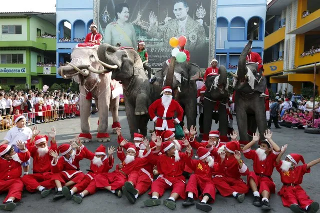 Children dressed as Santa Claus and elephants pose for a picture during a Christmas festival in a primary school in Ayutthaya, Thailand, December 24, 2015. (Photo by Jorge Silva/Reuters)