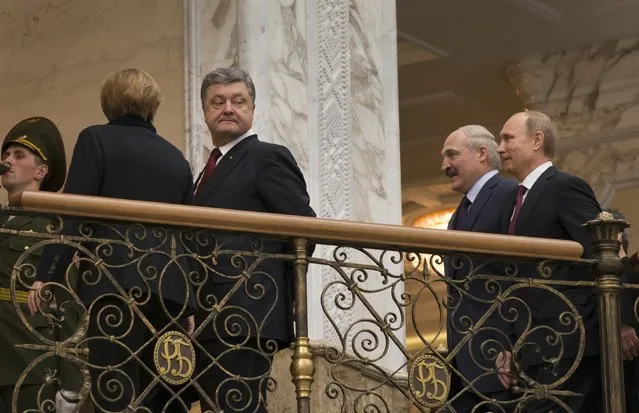 Ukrainian President Petro Poroshenko, left, is followed by Russian President Vladimir Putin, right, and Belarusian President Alexander Lukashenko, heading for a broader meeting involving senior officials in Minsk, Belarus, Wednesday, February 11, 2015. (Photo by Sergei Grits/AP Photo)