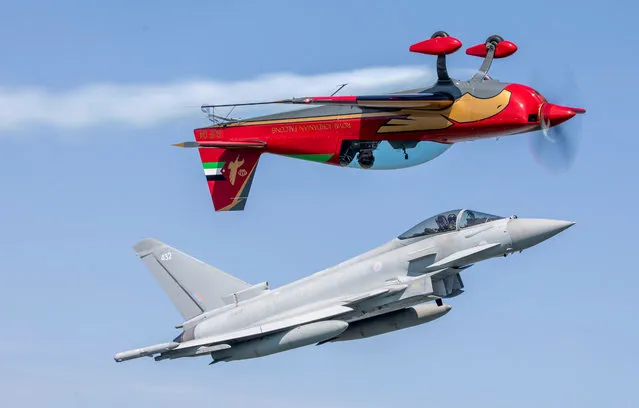 An RAF Coningsby Typhoon seen Friday, June 9, 2023 morning alongside one of the Royal Jordanian Falcons (red plane) prior to this weekend's RAF Cosford air show in Shropshire, UK, showing off various air manoeuvres and technical flying that the team will replicate over the coming days. (Photo by AS1 Edwards/RAF/South West News Service)