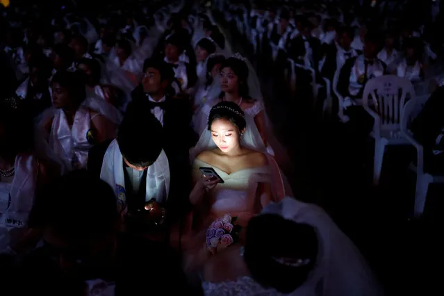 Couples attend a mass wedding ceremony of the Unification Church at Cheongshim Peace World Centre in Gapyeong, South Korea, August 27, 2018. (Photo by Kim Hong-Ji/Reuters)